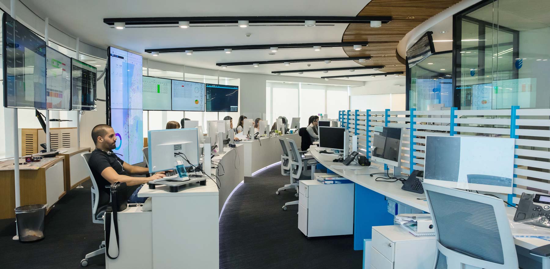 Electra FM employees work at a row of desks and computers