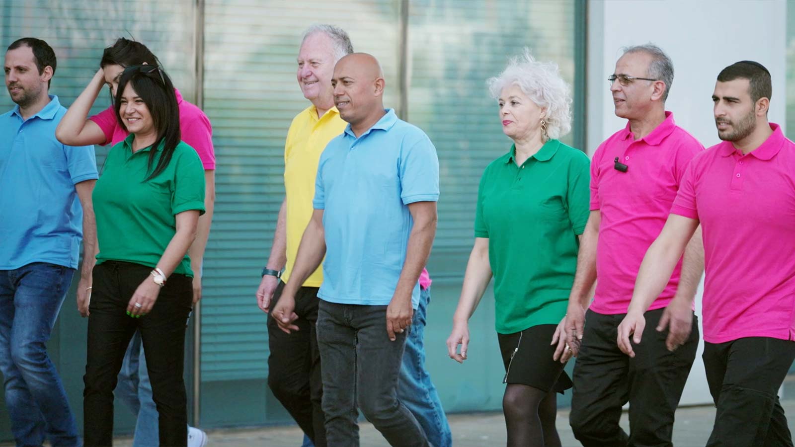 A group of Electra FM employees in colorful polo shirts