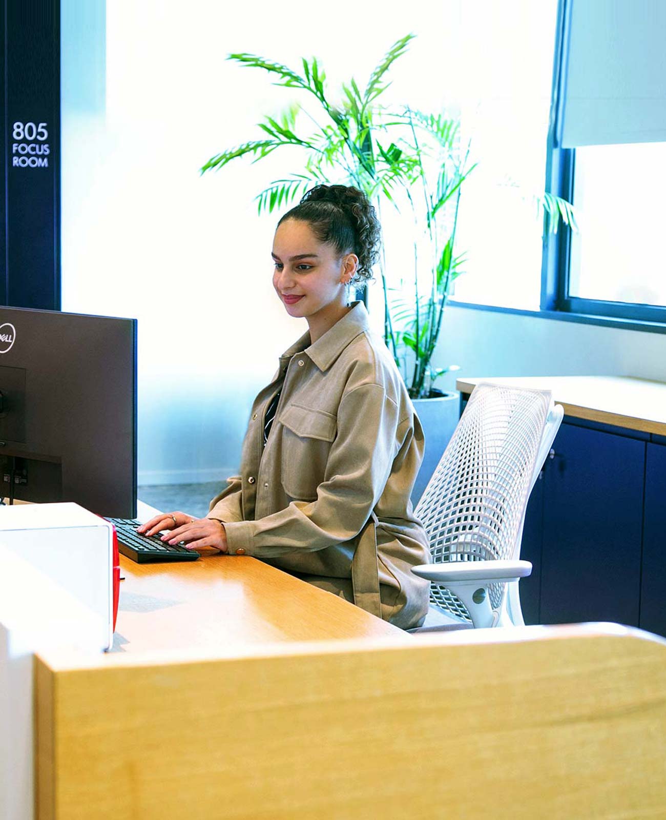 A young brunette receptionist at the desk