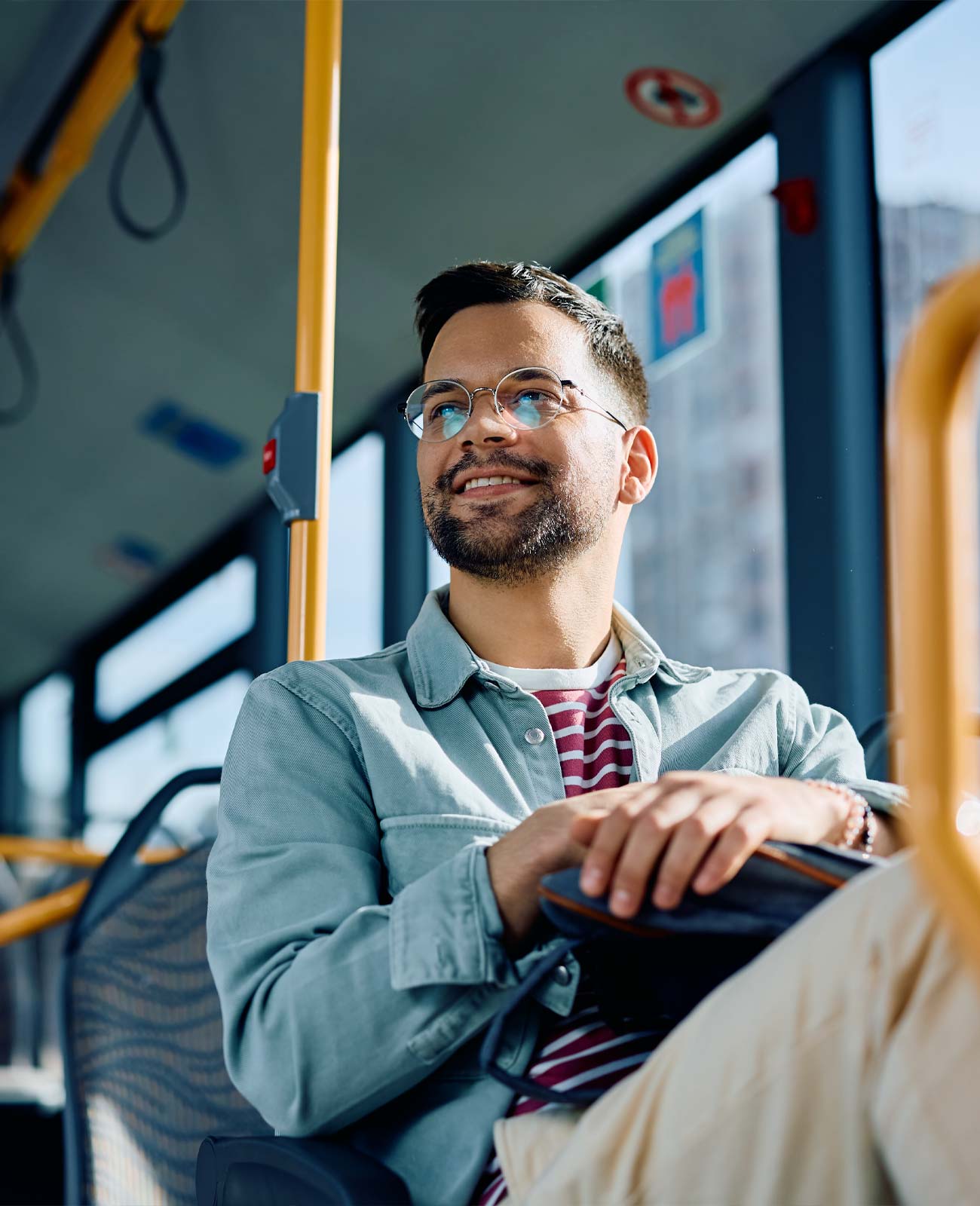 Young professional man with a blazer smiling in his commute