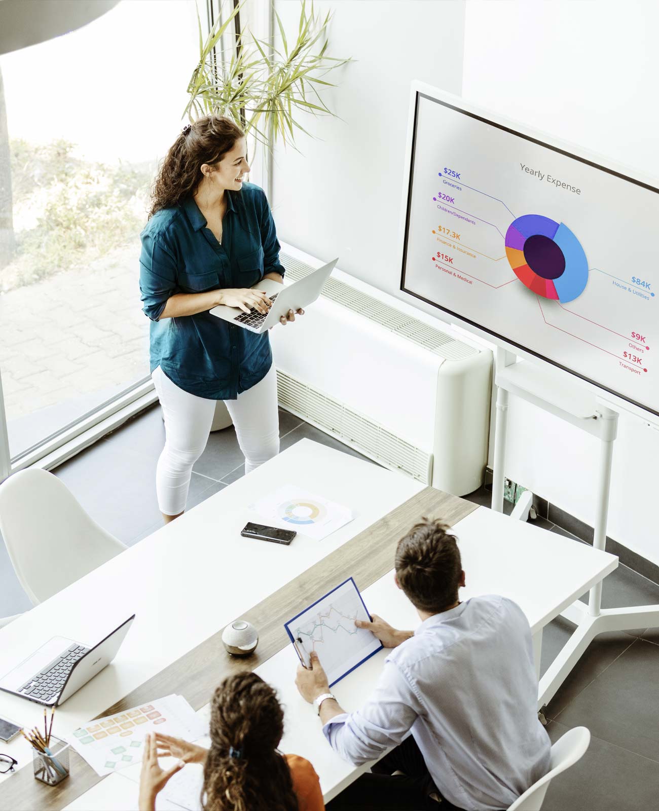 Office with team members with meeting with computers and display