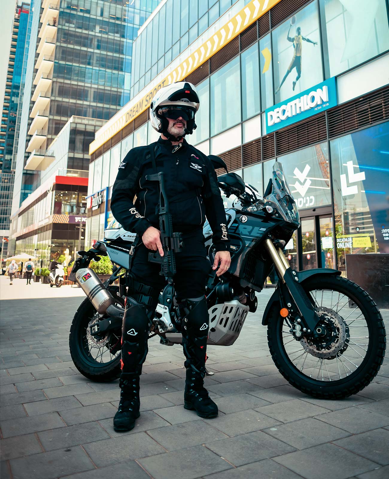 Electra Security member posing in front of a motorcycle