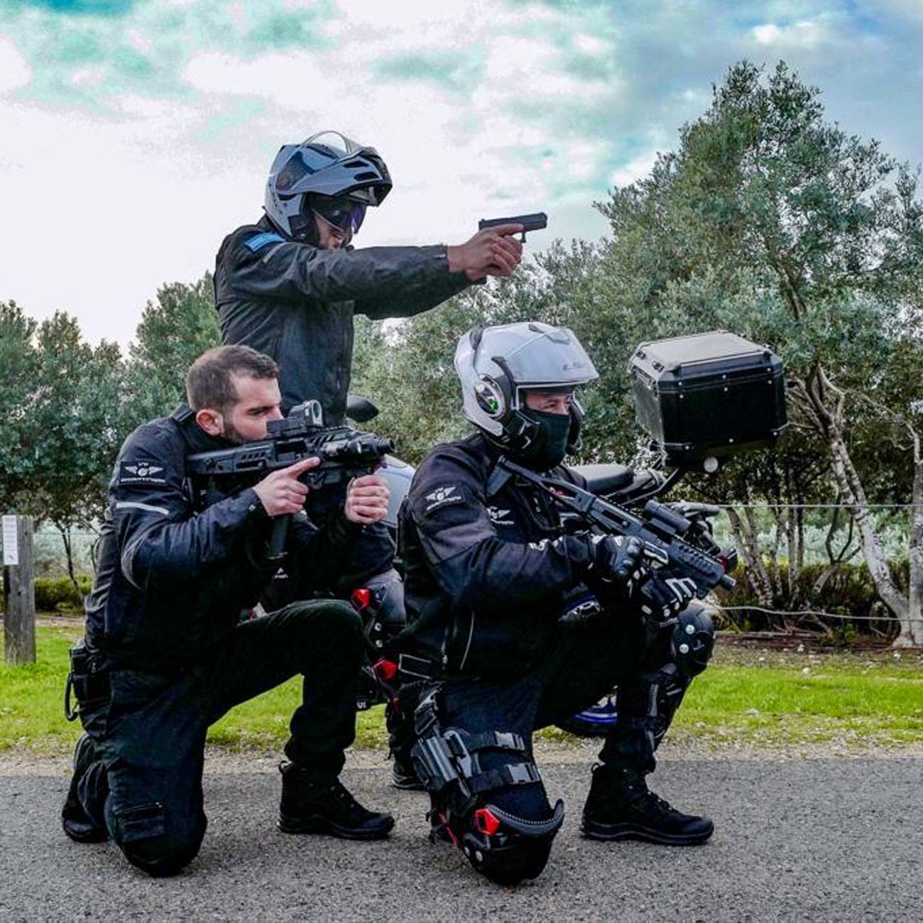 Electra security team together in tactical gear pointing weapons