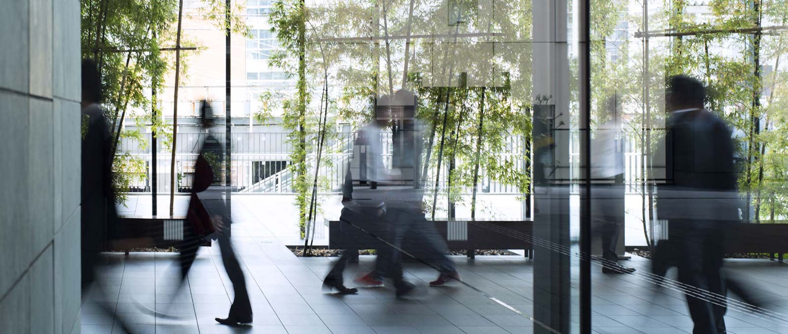 Time-lapse image of people walking in a modern office